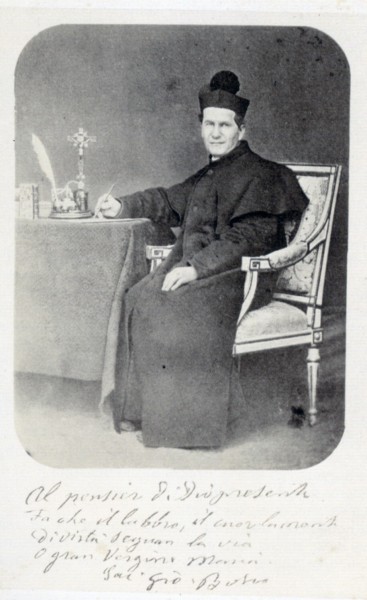 AnonymousUnknown author [Public domain], <a href="https://commons.wikimedia.org/wiki/File:Don_Bosco_scrittoe_Torino_1865-68.jpg"  target="_blank">via Wikimedia Commons</a>